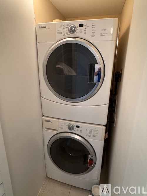 A stack of two white front loading washing machines.
