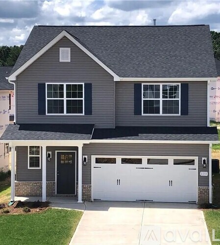 A two-car garage is attached to a house.