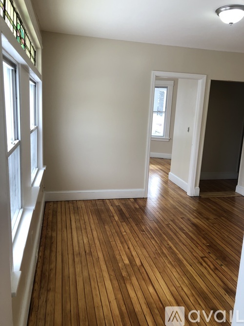 A room with wooden floors and white walls.