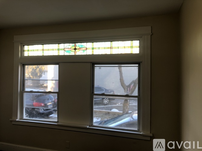 A window with a stained glass design in the middle.