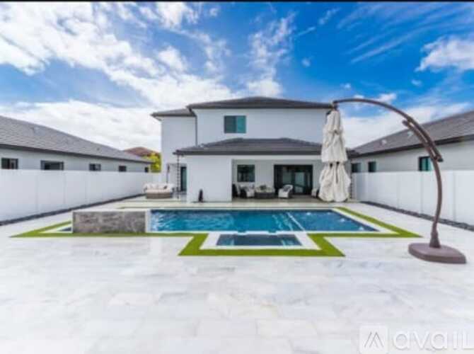 A modern house with a pool in the backyard.