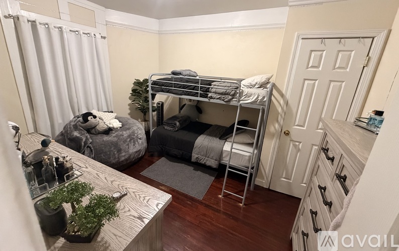 A room with a bunk bed and a couch.
