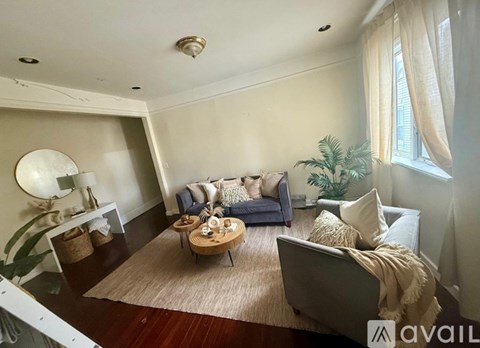 A living room with a grey couch and a wooden coffee table.
