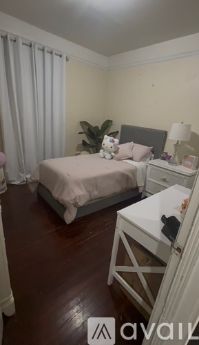 A bedroom with a bed, nightstand, and chair.