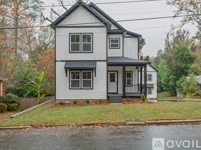 A two-story house with a grey and white exterior is for sale.