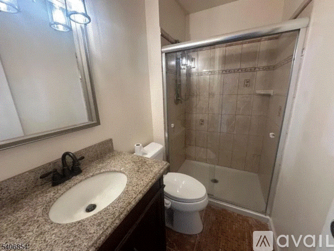 A bathroom with a sink, toilet, and shower.