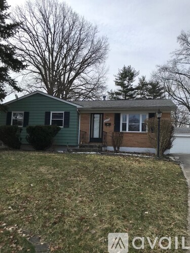 A house with a green exterior and a brown door.