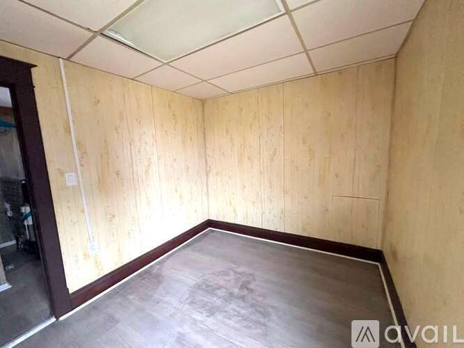 A room with wooden walls and a wooden floor.