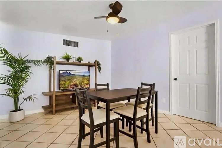 A dining room with a wooden table and chairs.