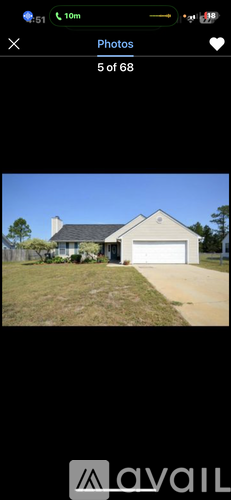 A house with a white garage door and a brown roof.