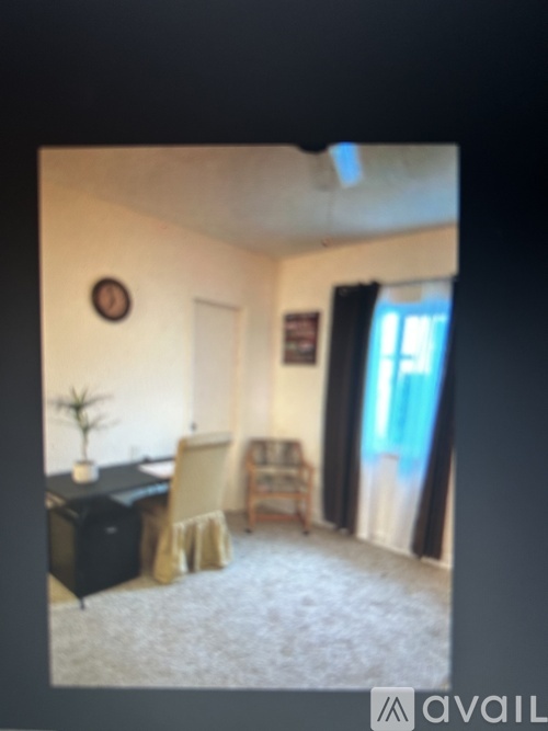 A room with a desk and a chair.