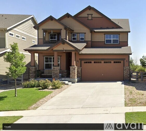 A two-story house with a garage is for sale.