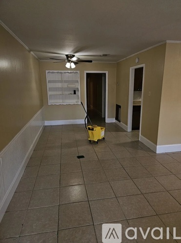 A room with a yellow machine on the floor.