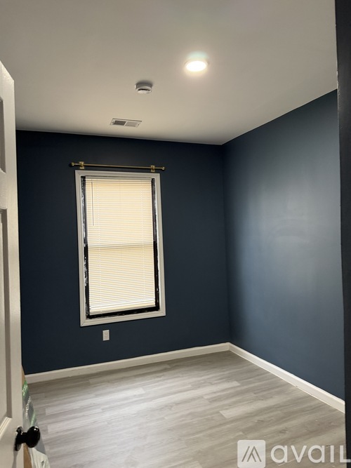A room with a window and a white door.