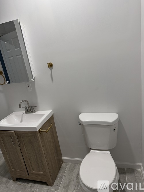 A white toilet sits next to a sink in a bathroom.