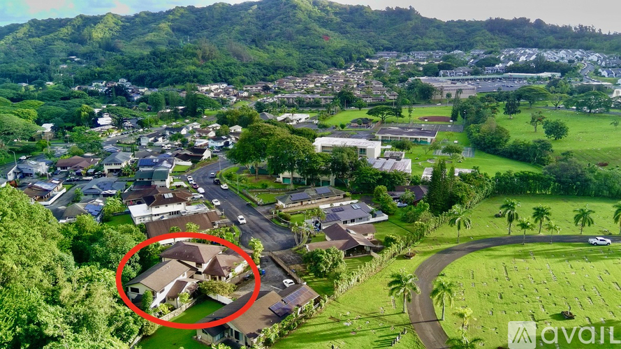 A bird's eye view of a residential area with a house circled in red.