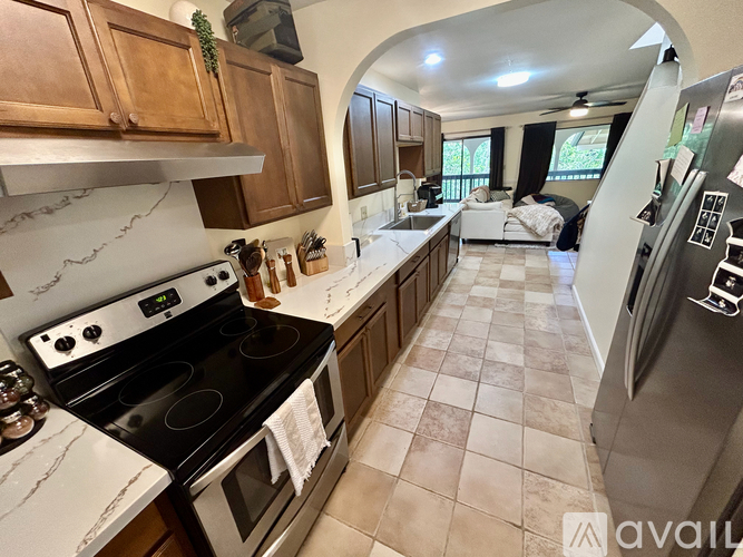 A kitchen with a black stove top oven and a black refrigerator.