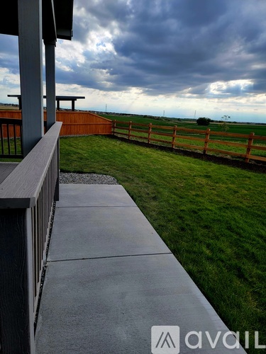 A wooden fence borders a grassy field.