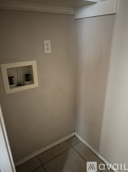 A small white shelf with three items on it.