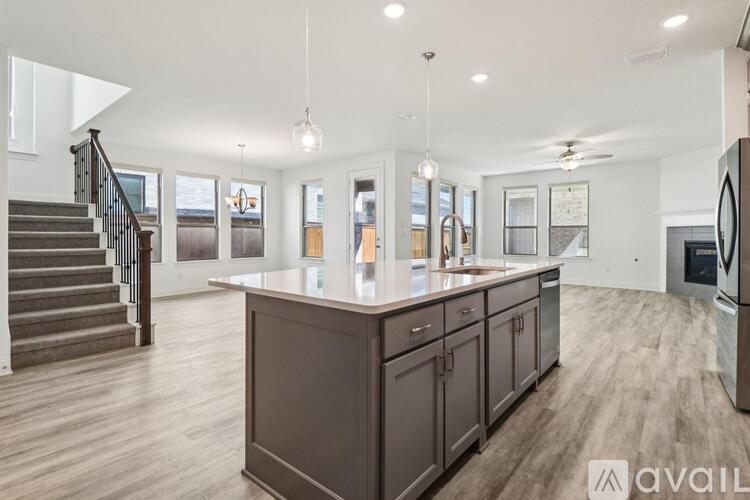 A spacious kitchen with dark wood cabinets and a central island.