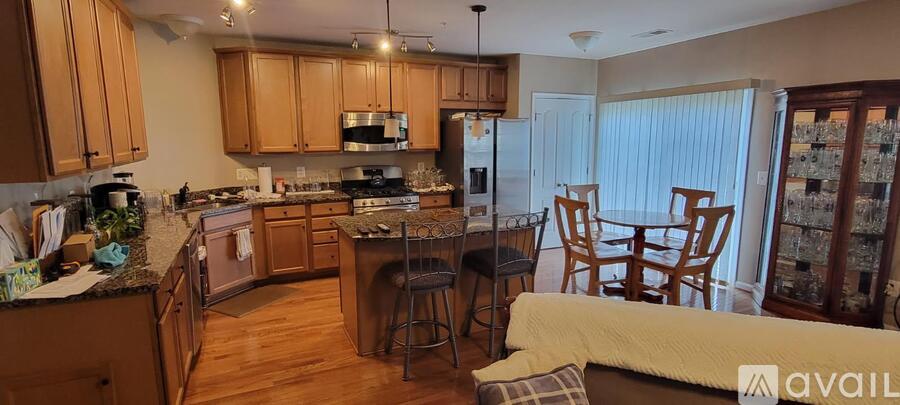 A kitchen with wooden cabinets and a dining table.