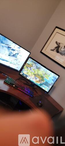 Two laptops are open and being used for gaming.