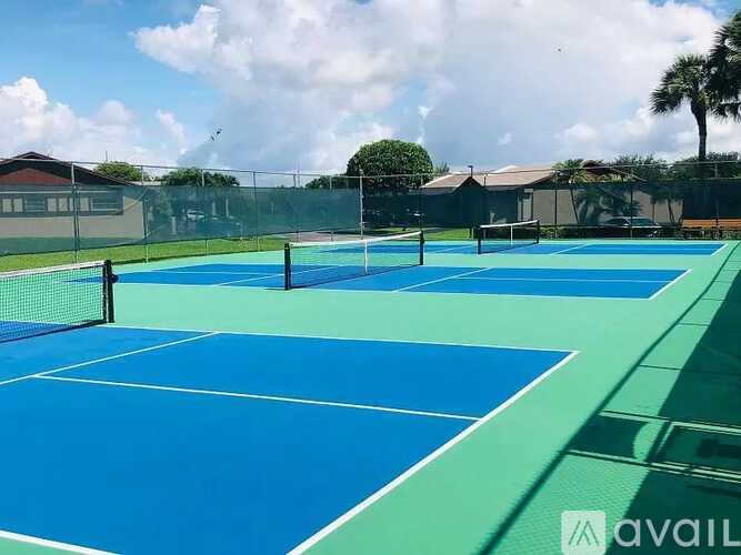 A tennis court with a green border and white lines.