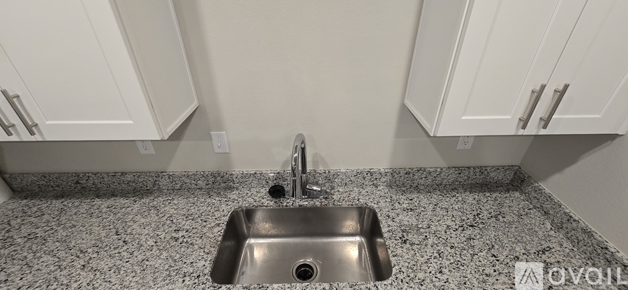 A kitchen with a sink and cabinets.