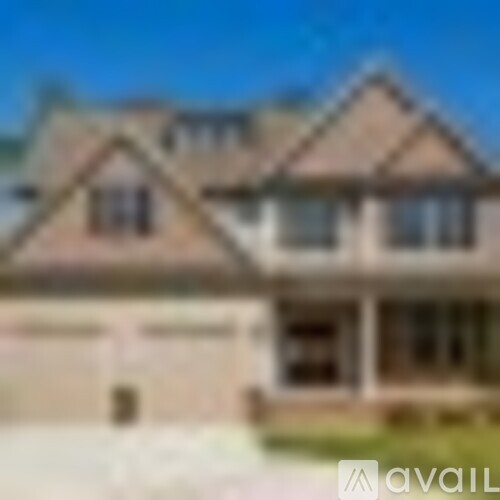 A house with a brown roof and a garage door.