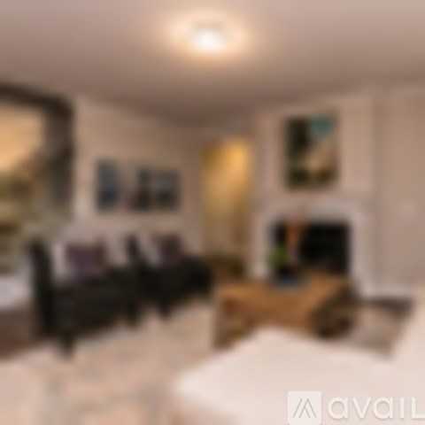 A living room with a couch and a fireplace.