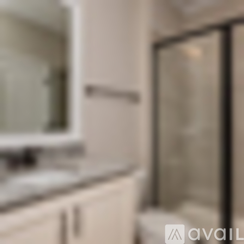 A kitchen with white cabinets and a glass door cabinet.