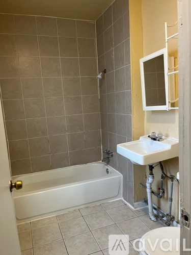 A bathroom with a white tub and sink.