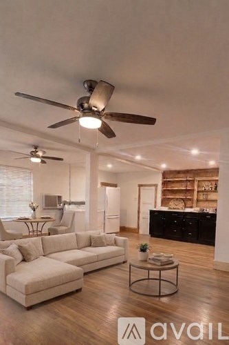 A living room with a large sectional sofa and a coffee table.