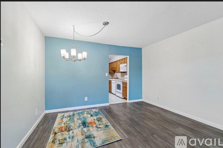 A room with a blue wall and a chandelier.