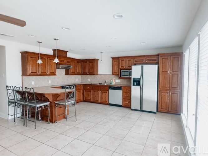 A kitchen with wooden cabinets and a white refrigerator.