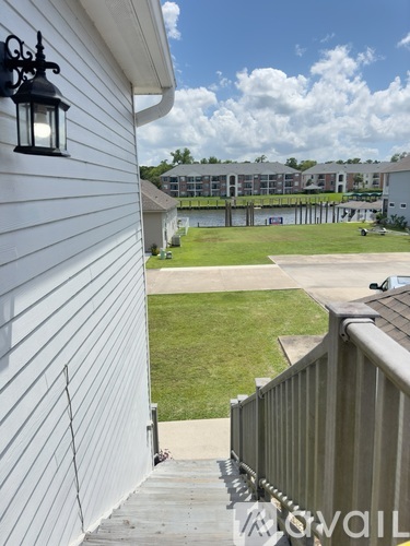 A white house with a wooden deck and a black lantern on the wall.