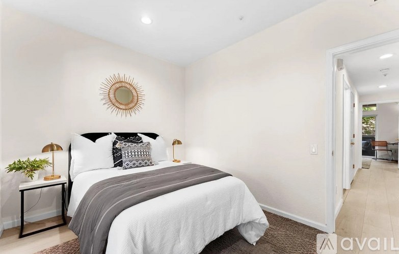 A bedroom with a large bed and a mirror on the wall.