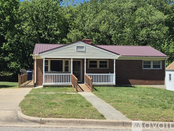 A small house with a porch and a covered front door.