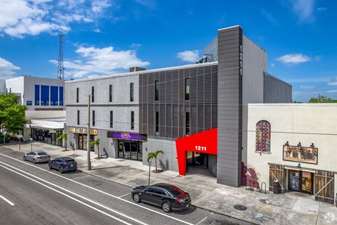 A street view of a building with the number 1211 on it.