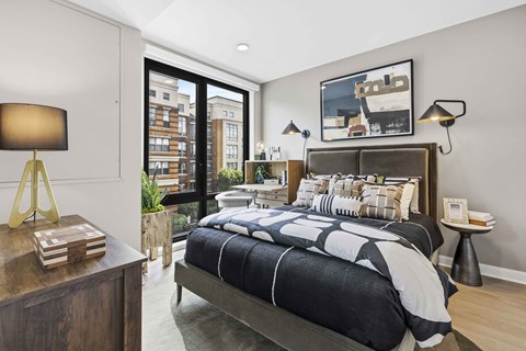 A bedroom with a large bed and a view of the city.
