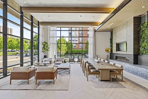 A modern living room with a long table and chairs.