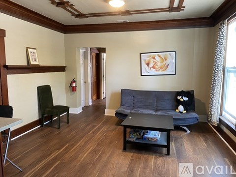 A living room with a grey sofa and a black coffee table.