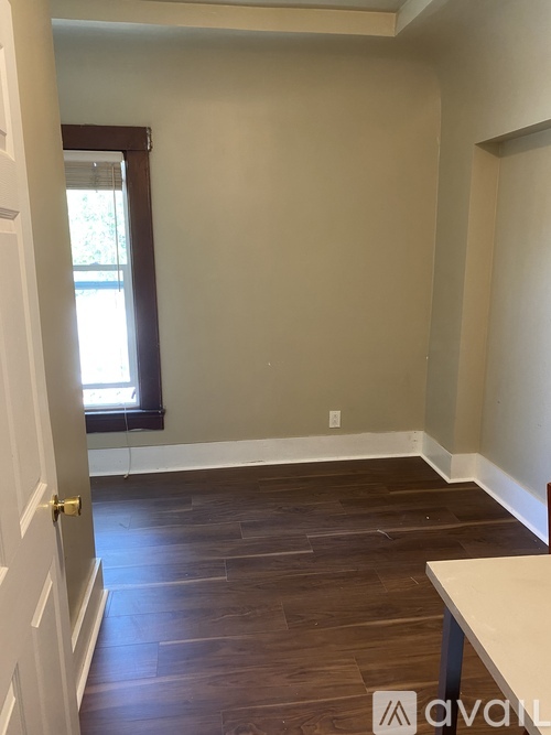 A room with wooden floors and a window.