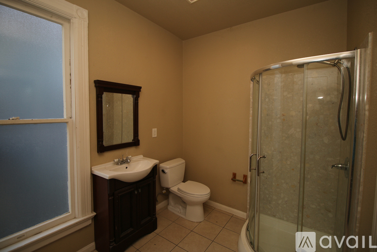 A bathroom with a toilet, sink, and shower.