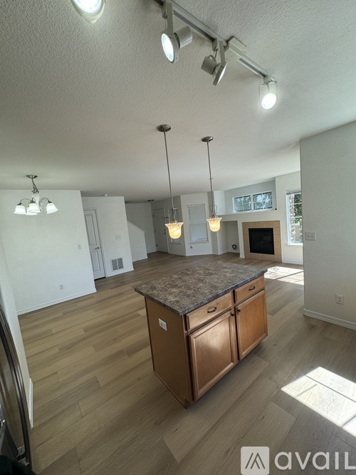 A kitchen with wooden cabinets and a granite countertop.