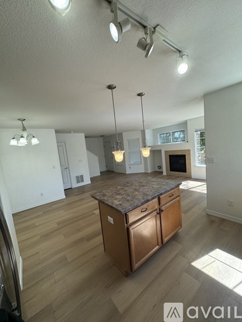 A kitchen with wooden cabinets and a granite countertop.