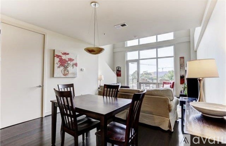 A dining room with a wooden table and chairs.