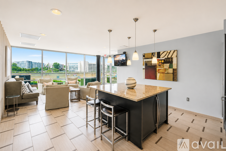 A kitchen with a bar and a dining table with chairs.