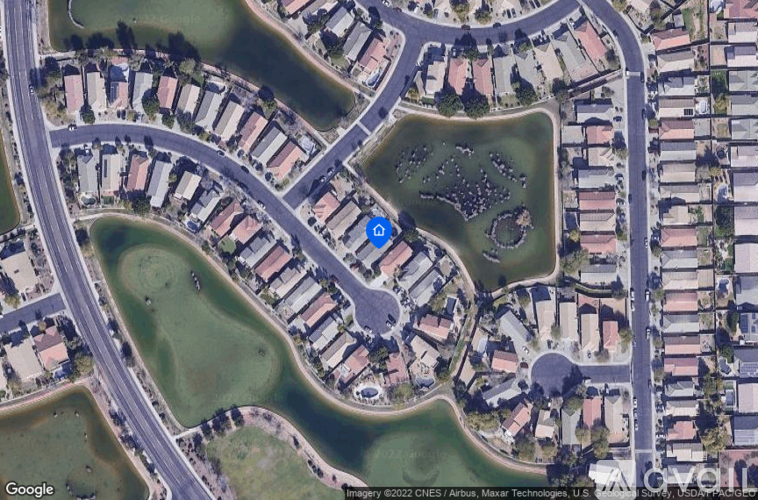 A satellite image of a neighborhood with a blue marker in the middle of a green space.
