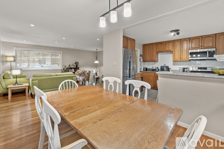 A modern kitchen with a dining table and chairs.